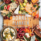 De voorkaft van het kookboek Borrelplanken. Te zien is een mooie sfeerimpressie met een robuuste houten serveerplank die aan de linker en rechterkant rijkelijk gevuld is met gevarieerde mix aan borrelhapjes. Ter hoogte van het midden van de serveerplank staat de tekst 'Onweerstaanbare borrelplanken, heerlijk om te delen'.