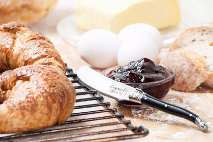 Een sfeerimpressie van het botermesje met vers afgebakken croissantjes en een glazen schaaltje met aardbeienjam.